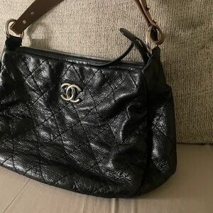 This CHANEL On The Road bag is a stylish accessory for any woman.